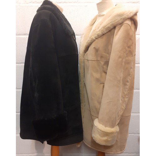 62 - Dennis Basso- Two ladies sheepskin coats comprising a black example (2 front buttons missing) size X... 