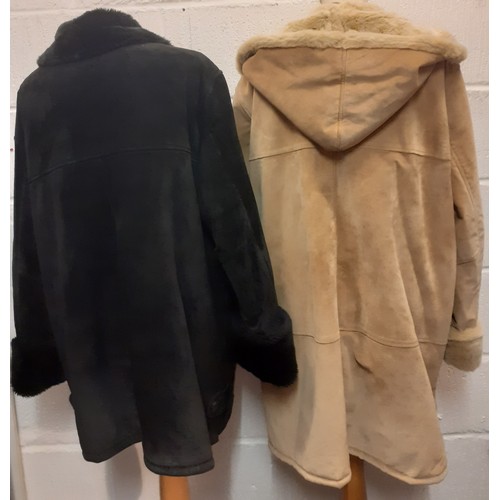 62 - Dennis Basso- Two ladies sheepskin coats comprising a black example (2 front buttons missing) size X... 