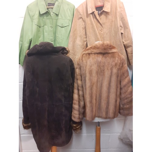 63 - A group of ladies jackets to include a ladies brown suede and faux raccoon fur hooded coat approx 50... 