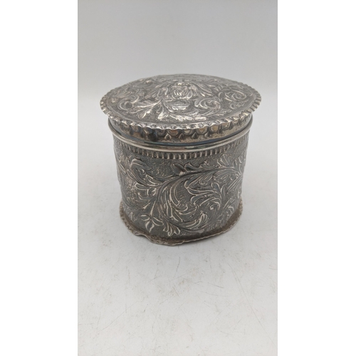 198 - A silver floral embossed dressing table lidded pot having a gilt interior, hallmarked London 1885, 1... 