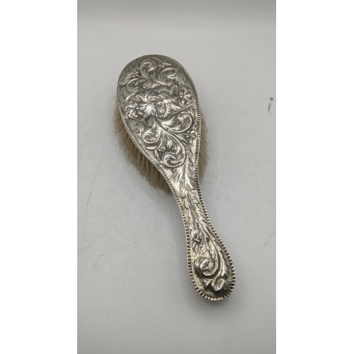 199 - Silver dressing table items to include a rectangular form with embossed decoration depicting a centr... 