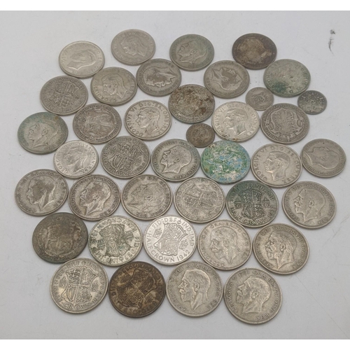 201 - A collection of 1920s/1946 silver British coinage to include half crowns, and others, total weight 5... 