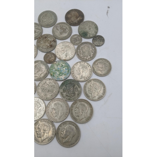 201 - A collection of 1920s/1946 silver British coinage to include half crowns, and others, total weight 5... 