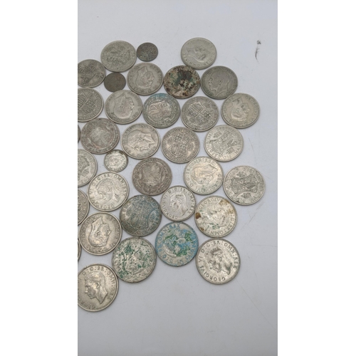 202 - A collection of 1920s/1946 silver British coinage to include half crowns and others, total weight 50... 