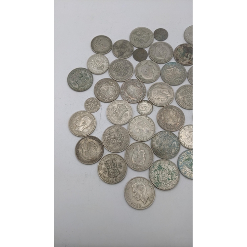 202 - A collection of 1920s/1946 silver British coinage to include half crowns and others, total weight 50... 