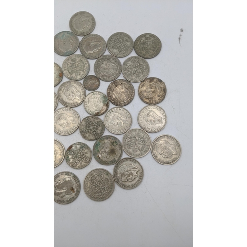 204 - A collection of 1920s/1946 silver British coinage to include two shillings and others, total weight ... 