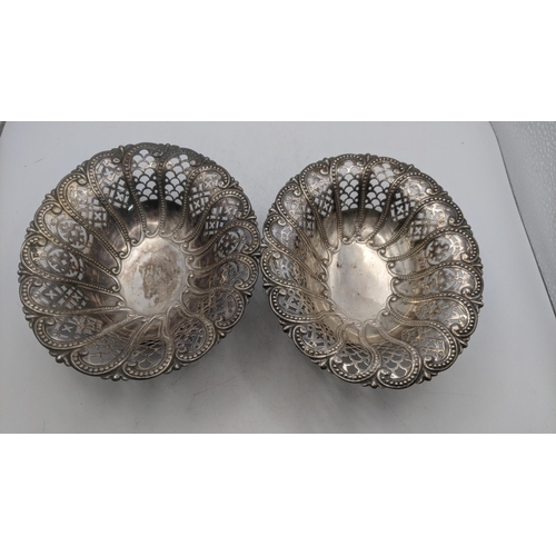 212 - A pair of Atkins Brothers silver pierced pedestal pin dishes of oval form, bearing different dates t... 