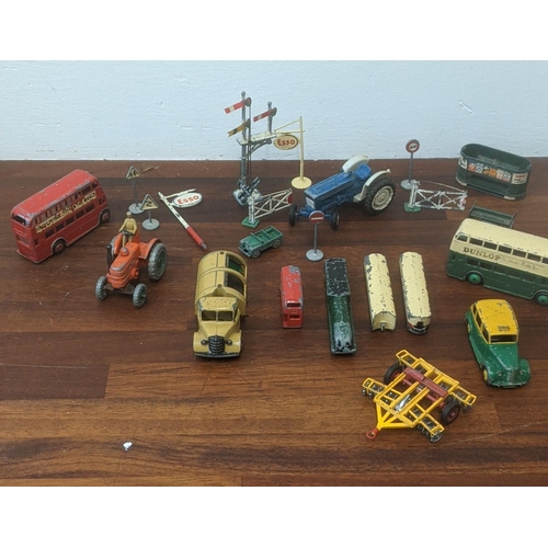 217 - Seven Dinky diecast model vehicles to include trains, a bus, a tractor, a rubbish truck, along with ... 