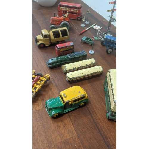 217 - Seven Dinky diecast model vehicles to include trains, a bus, a tractor, a rubbish truck, along with ... 