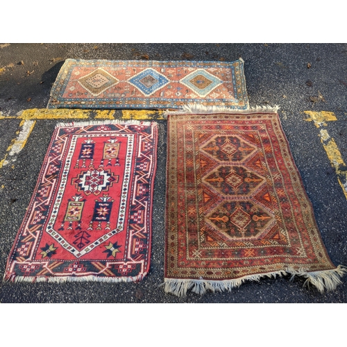 356 - Three rugs, one runner with three diamond shaped motifs on a red background another decorated with a... 