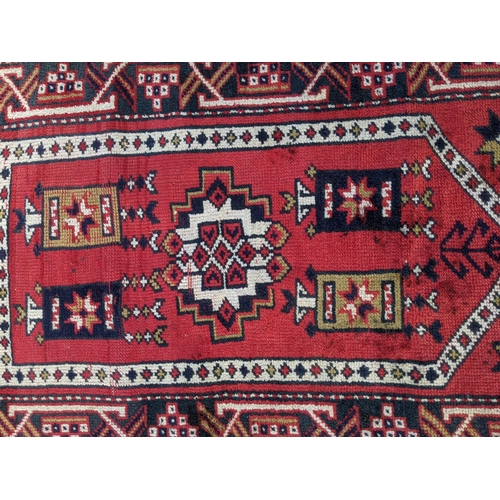 356 - Three rugs, one runner with three diamond shaped motifs on a red background another decorated with a... 