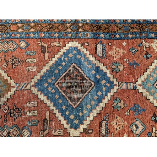 356 - Three rugs, one runner with three diamond shaped motifs on a red background another decorated with a... 