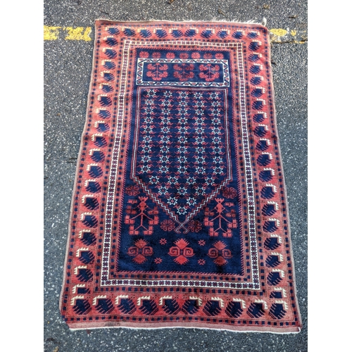 357 - A Persian rug decorated with repeating gulls with a red border on a blue background, 178cm 1 x 190cm... 