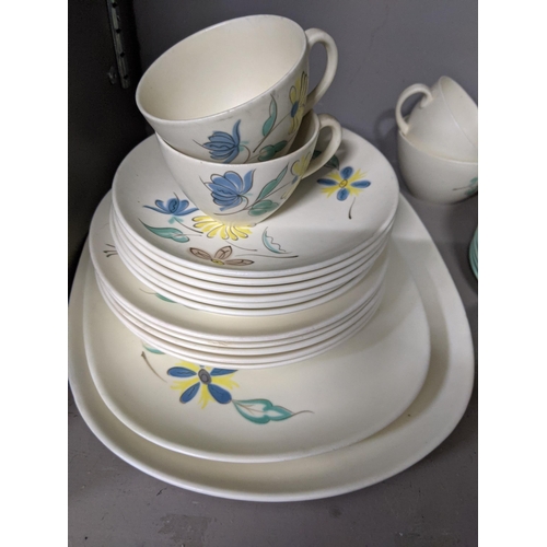 363 - A part Poole pottery dinner service to include cups, saucers, dinner plates, meat plates and other i... 