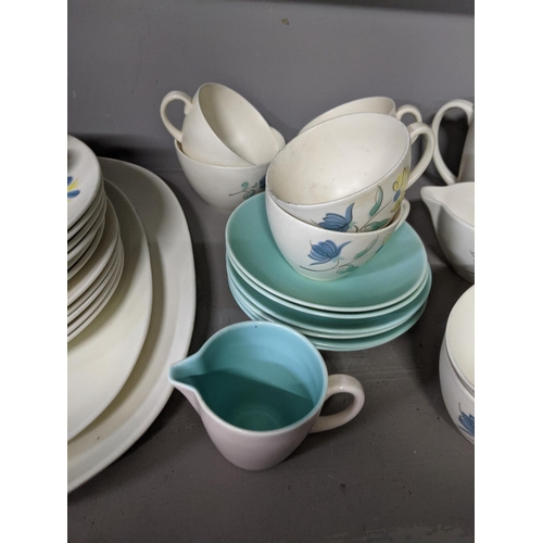 363 - A part Poole pottery dinner service to include cups, saucers, dinner plates, meat plates and other i... 