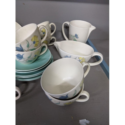 363 - A part Poole pottery dinner service to include cups, saucers, dinner plates, meat plates and other i... 