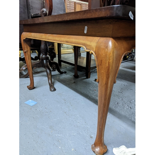 373 - A mahogany table with later top on shaped legs and pad feet 60cm x 97cm x 64cm, along with an oak tw... 