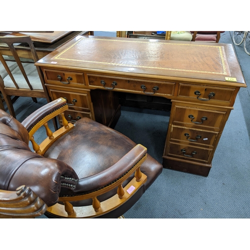 377 - A reproduction yew wood twin pedestal writing desk with gilt tooled leather scriber, above one long ... 