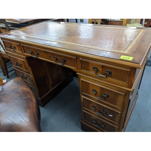 377 - A reproduction yew wood twin pedestal writing desk with gilt tooled leather scriber, above one long ... 