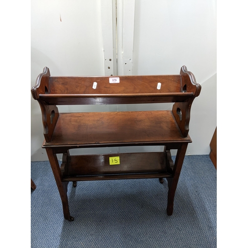 379 - Edwardian mahogany bookstand, three tiers with cut-out carrying handles and Art Nouveau motif standi... 