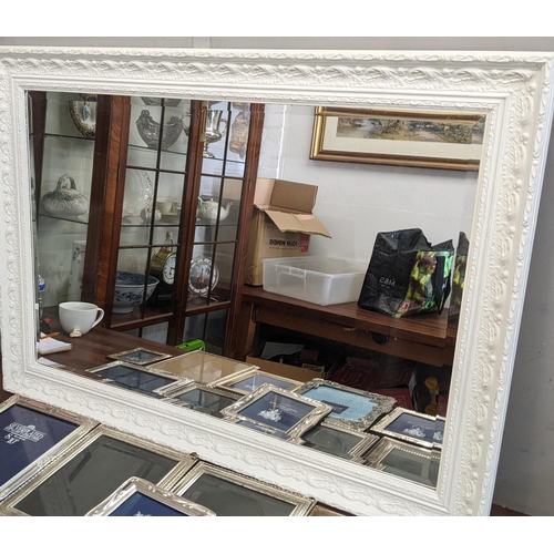 302 - A collection of silver plated photo frames, along with a mirror with an ornate white frame, 106cm x ... 