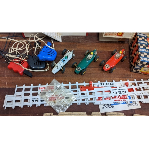 308 - Scalextric equipment to include three racing cars, trackside buildings, track, figures and other ite... 