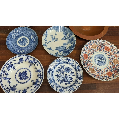 317 - Japanese plates to include Imari and blue and white examples, a Meissen Onion pattern dish, a copper... 