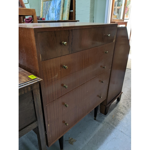 385 - A retro mid-century walnut veneered chest of five drawers, with brass knop handles, on dansette legs... 