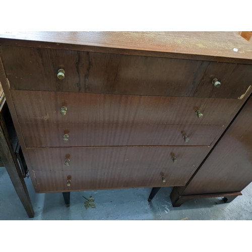 385 - A retro mid-century walnut veneered chest of five drawers, with brass knop handles, on dansette legs... 