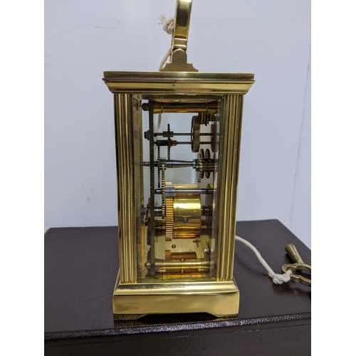 386 - A Charles Frodsham brass cased, five window carriage clock, in original box, with key, guarantee and... 