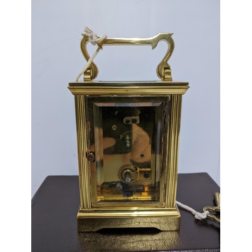 386 - A Charles Frodsham brass cased, five window carriage clock, in original box, with key, guarantee and... 