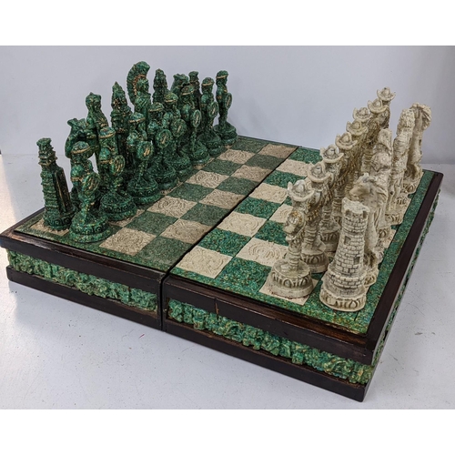 411 - A resin folding chess board complete with chess pieces
Location:A2B If there is no condition report ... 