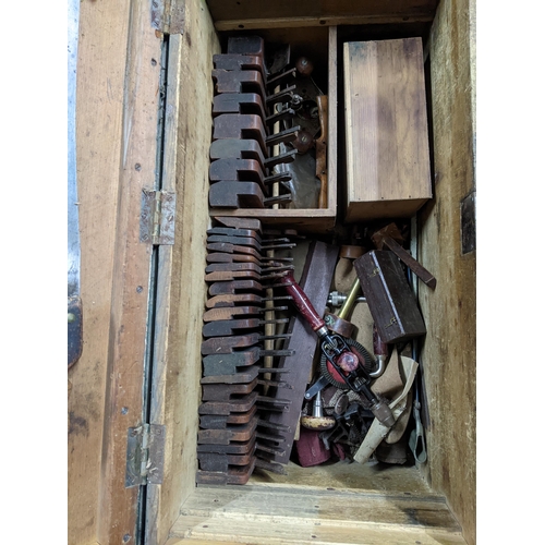 432 - A large wooden green painted tool chest with fitted interior with various woodworking tools to inclu... 