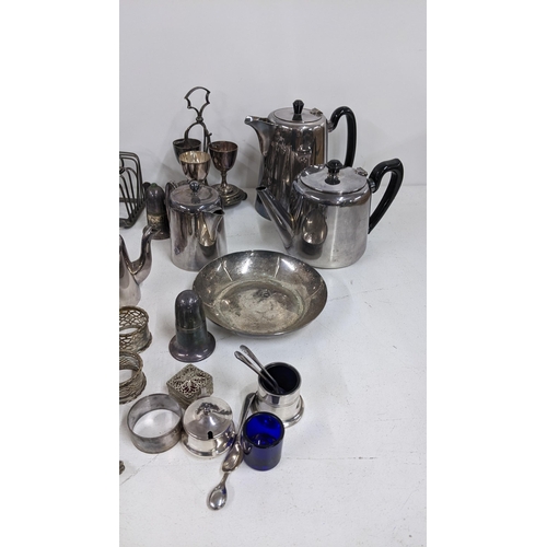 466 - Mixed silver plate to include a pair of candlesticks, boxed and loose cutlery, toast racks and other... 