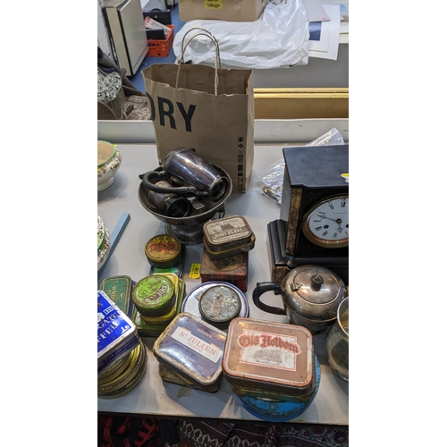 494 - A mixed lot to include a slate mantel clock, a silver plated teapot with milk jug, vintage tins, a W... 