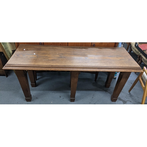 497 - An early 20th century oak hall table having a stepped cornice and on six tapering spade legs, 71cm h... 