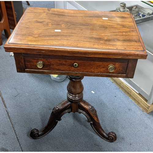 498 - An early Victorian rosewood fold over games table, the swivel top opening to reveal a games board, b... 