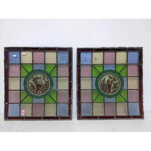 501 - Two Victorian stained glass window panels, each decorated with a bird amongst foliage to the centre,... 