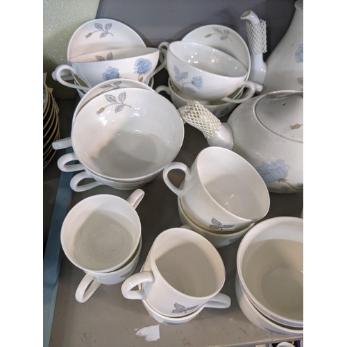 393 - A Wedgwood Ice Rose pattern dinner service to include plates, saucers, cups, soup bowls, a milk jug,... 