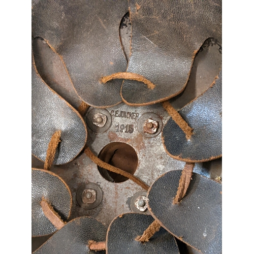 459 - A Prussian helmet stamped Junker 1915, with a leather interior, A/F and a World War II helmet, stamp... 