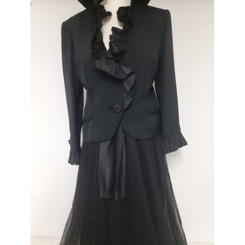 52 - Hartnell, British Designer- A black evening jacket with ruffled collar and cuffs approx 38