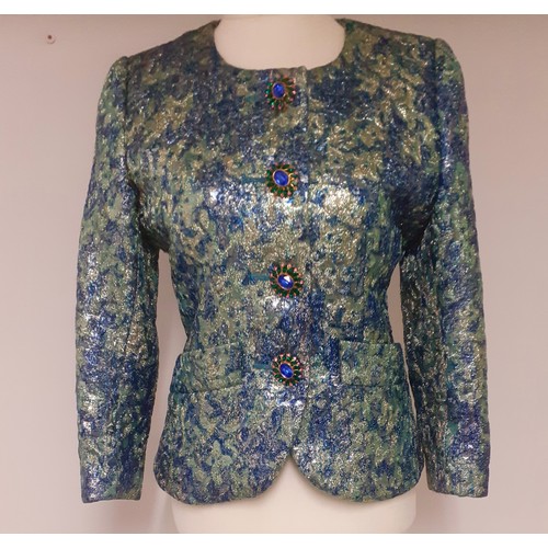 Yves Saint Laurent, French Designer- A Saint Laurent Rive Gauche blue, green, gold and silver lame padded jacket having a green satin lining and bejewelled buttons to the front fastening and cuffs, European size 36 (chest size 36" x 23.5" long ), made in France. Location:Rail
If there is no condition report, please request.