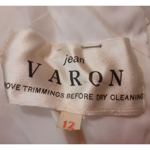 57 - Jean Varon, British Designer-A 1960's white wedding dress with ruffled collar and netted overgarment... 