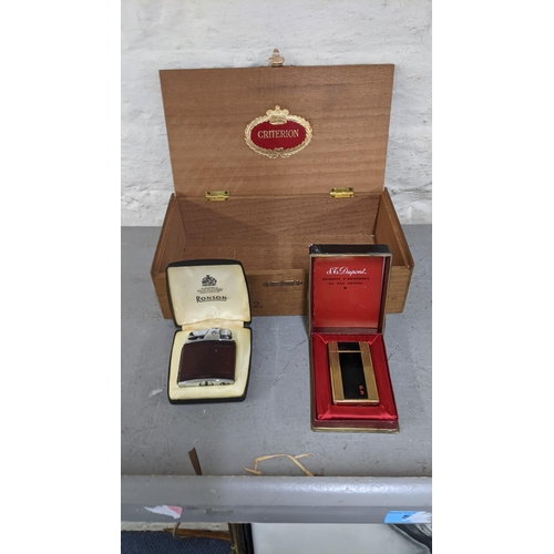 101 - Two vintage cigarette lighters in their case to include a black lacquered gold plated Dupont lighter... 