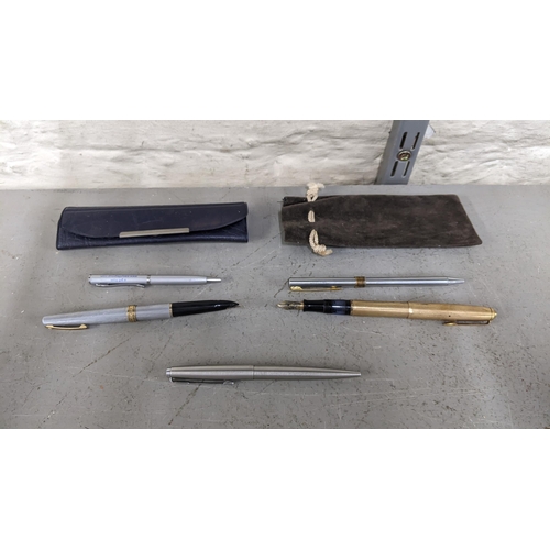 104 - A collection of pens to include a Mars Staedtler 14ct gold plated and gold nibbed fountain pen, a Sh... 