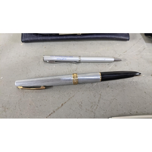 104 - A collection of pens to include a Mars Staedtler 14ct gold plated and gold nibbed fountain pen, a Sh... 