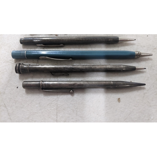 110 - A group of five propelling pencils to include two hallmarked silver examples, one Eversharp blue lac... 