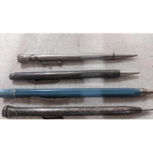 110 - A group of five propelling pencils to include two hallmarked silver examples, one Eversharp blue lac... 