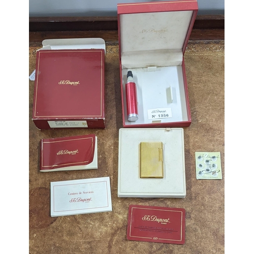 114 - A boxed gold plated DuPont lighter with embossed decoration, engraved MV, 3.5cm x 6cm
Location: CAB
... 