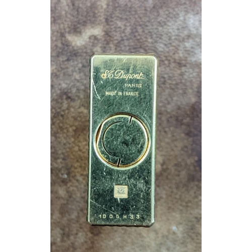 114 - A boxed gold plated DuPont lighter with embossed decoration, engraved MV, 3.5cm x 6cm
Location: CAB
... 